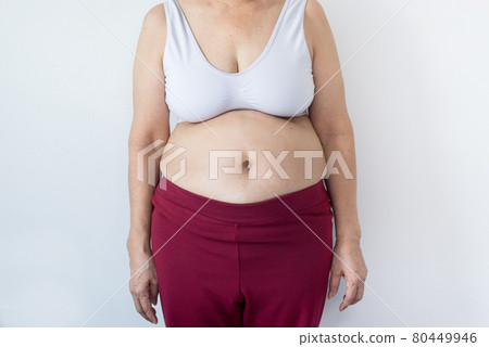 Overweight senior woman pinching her fat body,Cellulite around her belly button,Bloated belly,Healthy lifestyle concept 80449946