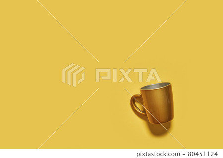 Golden drink cup on yellow background Golden drink cup on yellow background 80451124
