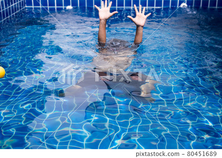 Blurred of hands man drowning in swimming pool 80451689