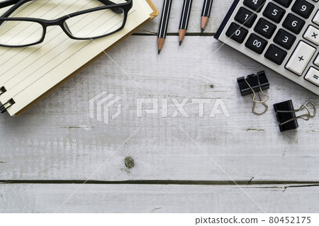 Top view of financial office workspace and copy space with calculator, notebook, pencil on white wood desk 80452175