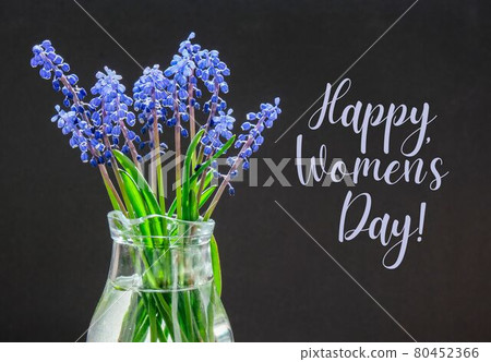 HAPPY WOMENS DAY Bouquet of blue Muscari. Black background. Spring bulbous flowers. Flower shop concept 80452366