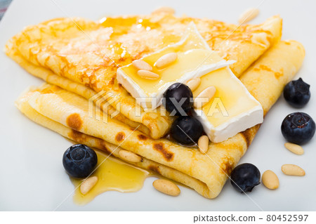 Pancakes with cheese brie and honey 80452597