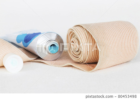 topical medication with roll bandage for first aid accident arrangement flat lay  80453498