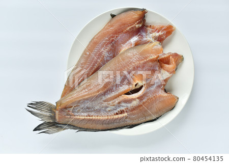 Sun-dried snakehead fish in a white plate on a white background 80454135