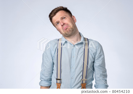 Angry emotion on face of young man. Man is about to start crying. Angry emotion on face of young man. Man is about to start crying. 80454210
