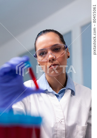 Specialist woman doctor holding blood medical vacutainer analyzing dna infection expertise 80455061