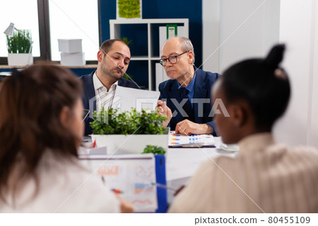 Focused mixraced professional team business people work together Focused mixraced professional team business people work together 80455109