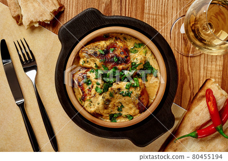 Georgian chicken Shkmeruli stewed in milk with nuts and garlic Georgian chicken Shkmeruli stewed in milk with nuts and garlic 80455194