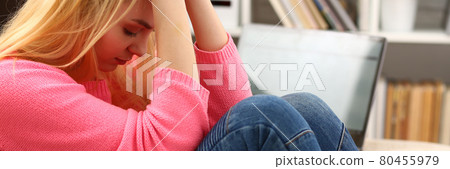 Unhappy lonely depressed woman sitting on the couch Unhappy lonely depressed woman sitting on the couch 80455979