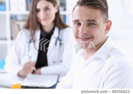 Satisfied happy handsome smiling male patient with doctor 80456823
