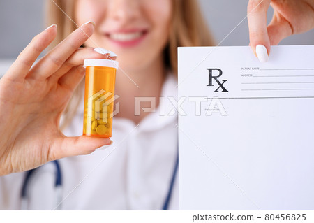 Female doctor hands hold prescription 80456825