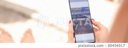 Woman is editing taken photo on smartphone Woman is editing taken photo on smartphone 80456917