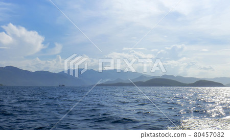 coastline of Vinperl Island, South China Sea, hills, sunlight, a small ship in the background 80457082