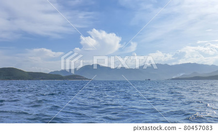 coastline of Vinperl Island, South China Sea, hills, sunlight, a small ship in the background 80457083