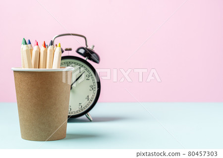 Back to school banner with black alarm clock and pencil in coffee cup Back to school banner with black alarm clock and pencil in coffee cup 80457303
