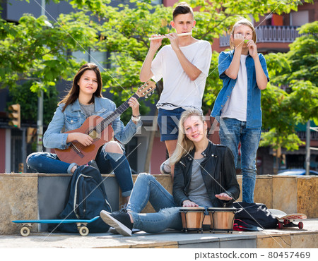 Two girls and two boys with musical instruments Two girls and two boys with musical instruments 80457469