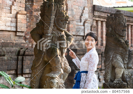 A woman in a traditional costume (Kebaya) at a traditional temple in Bali 80457566