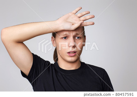 upset young guy in t-shirt forgot something or made a mistake 80457591