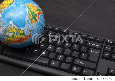 Globe on a computer keyboard. Traveling around the world through online services. Online booking 80458770