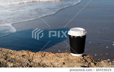 Cup of coffee on a table over blue sky and empty sea beachside. Summer holiday concept.Mock up, copy space 80459029