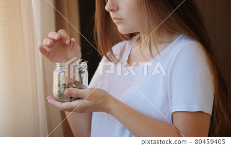 Turkish coins glass jar in woman hands. The paper currency of Turkey. Financial crisis and saving concept. 80459405