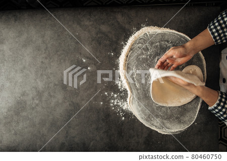 Hands making a pizza dough with flour 80460750