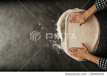 Hands making a pizza dough with flour Hands making a pizza dough with flour 80460905