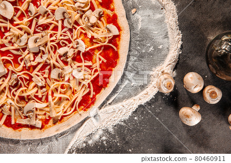 Semi finished pizza with cheese and tomato sauce Semi finished pizza with cheese and tomato sauce 80460911