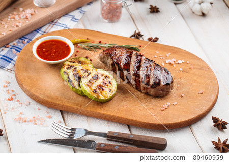 Grilled beef steak with squash slices and sauce Grilled beef steak with squash slices and sauce 80460959