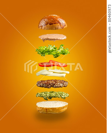 Floating burger ingredients on the yellow background Floating burger ingredients on the yellow background 80460973