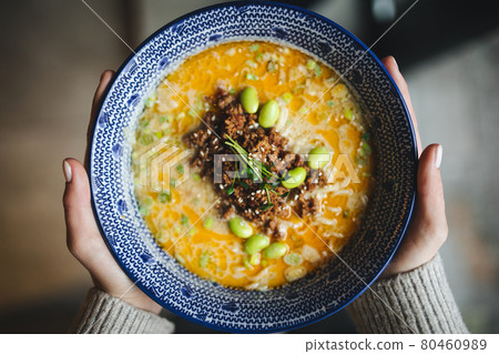 Hands holding a bowl of japanese ramen tantanmen Hands holding a bowl of japanese ramen tantanmen 80460989