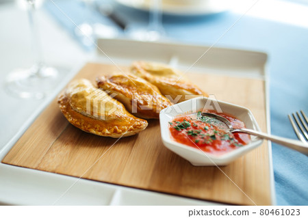 Spanish meat pies empanados with salsa sauce 80461023