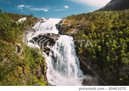 Kinsarvik, Hordaland, Norway. Waterfall Nyastolfossen In Hardangervidda Mountain Plateau. Nyastolsfossen in Spring Sunny Day. Height Of 115 m. Norwegian Landmark And Popular Destination Kinsarvik, Hordaland, Norway. Waterfall Nyastolfossen In Hardangervidda Mountain Plateau. Nyastolsfossen in Spring Sunny Day. Height Of 115 m. Norwegian Landmark And Popular Destination 80461070