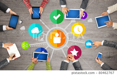 Top view of businesspeople sitting at table and using gadgets Top view of businesspeople sitting at table and using gadgets 80462767