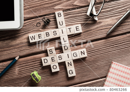 Conceptual media keywords on table with elements of game making crossword Conceptual media keywords on table with elements of game making crossword 80463266