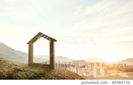 Conceptual image of concrete home sign on hill and natural lands 80464736