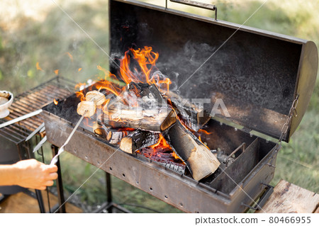 woman frying bread on a barbecue woman frying bread on a barbecue 80466955