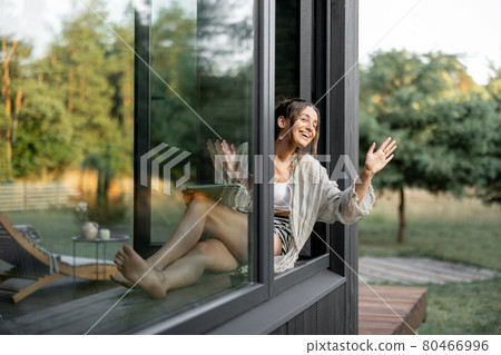 Woman enjoy nature at country house Woman enjoy nature at country house 80466996