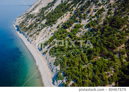 Coastline with sea and highest cliff with trees. Summer day on sea. Aerial view Coastline with sea and highest cliff with trees. Summer day on sea. Aerial view 80467879