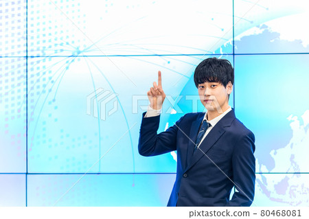 A businessman standing in front of a large display A businessman standing in front of a large display 80468081