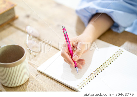 Woman studying at a wood desk [Parts cut] 80468779
