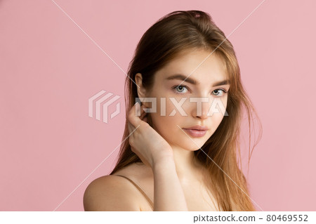 Close-up beautiful adorable young girl posing isolated over pink studio background. Natural beauty, spa, cosmetics and aesthetic cosmetology concept. Close-up beautiful adorable young girl posing isolated over pink studio background. Natural beauty, spa, cosmetics and aesthetic cosmetology concept. 80469552