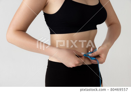 Crop image of young woman in lingerie isolated over gray studio background. Beauty, fitness, diet, sports, plastic surgery and aesthetic cosmetology concept. 80469557