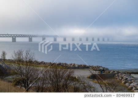 A bridge in fog. Blue ocean and mist in the background. Picture from the bridge connecting Sweden with Denmark 80469917