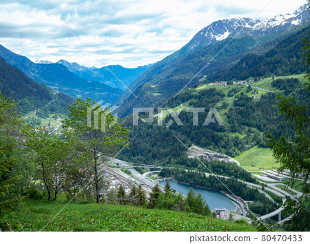 View from Gotthard pass street, Switzerland, down to the valley with infrastructure View from Gotthard pass street, Switzerland, down to the valley with infrastructure 80470433