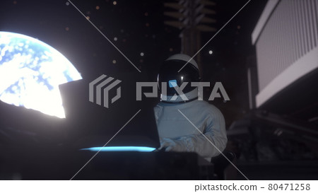 Astronaut works on his science laptop in a space colony on the moon. 3d rendering Astronaut works on his science laptop in a space colony on the moon. 3d rendering 80471258