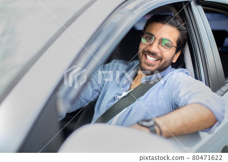 Handsome middle-eastern man driving car, shot from outside Handsome middle-eastern man driving car, shot from outside 80471622