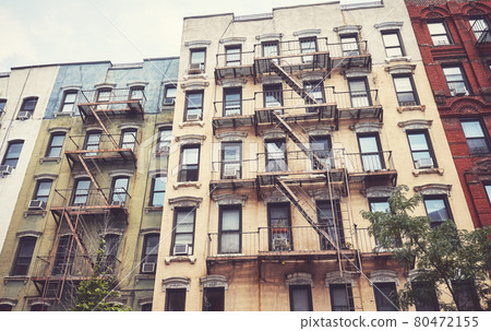 New York townhouses with iron fire escapes, color toning applied, USA. New York townhouses with iron fire escapes, color toning applied, USA. 80472155