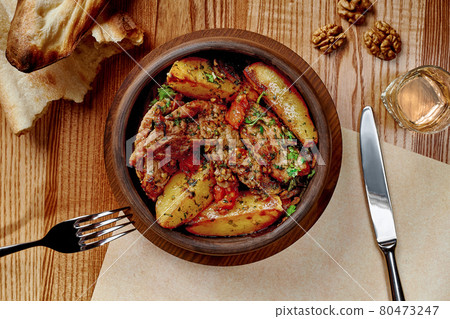 Ojakhuri from roasted lamb with potatoes in clay ketsi pan 80473247