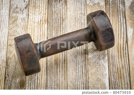 vintage iron dumbbell on wood vintage iron dumbbell on wood 80473910